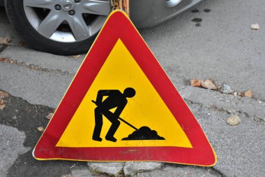Close up shot of warning signs with road sign