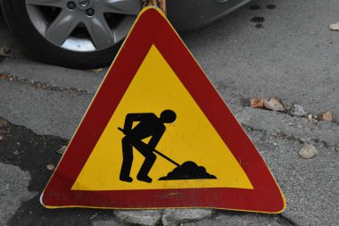 Close up shot of warning signs with road sign