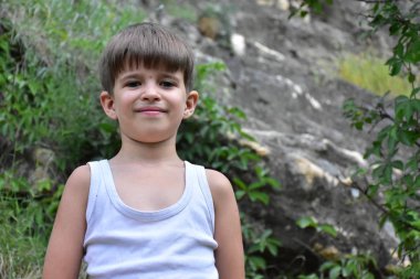 child in the background of mountains,