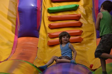 Çocuklar şişme kalede oynuyorlar.,