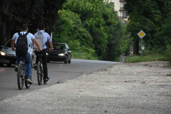 Two Men Riding Bicycles Asphalt Road Cars — ストック写真