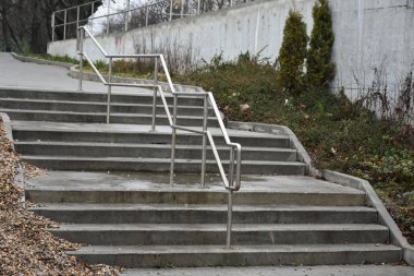 concrete staircase with iron handrail in a city park 