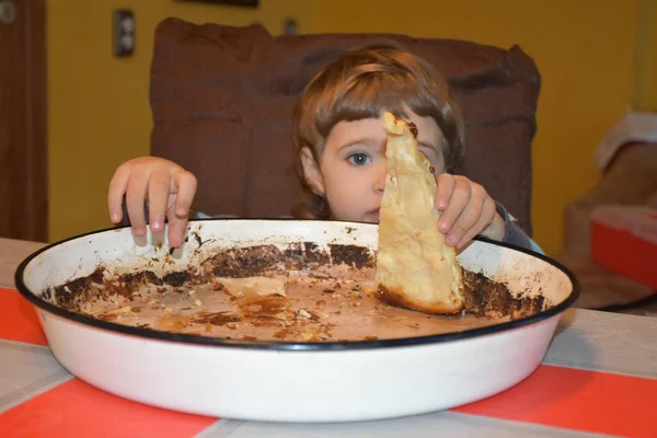 the child is eating pie