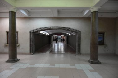 interior of underground subway tunnel with people 