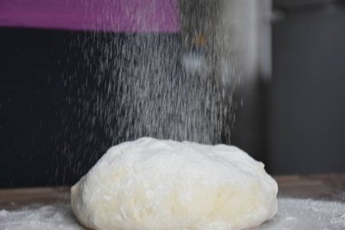 Kadın elleriyle hamur yoğurur.