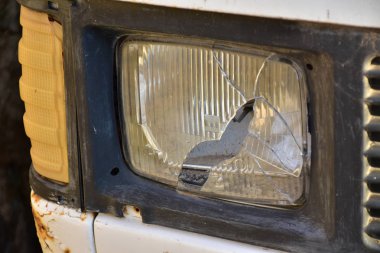 Closeup of old car with broken headlight