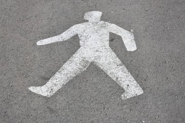 asphalt road with white human sign