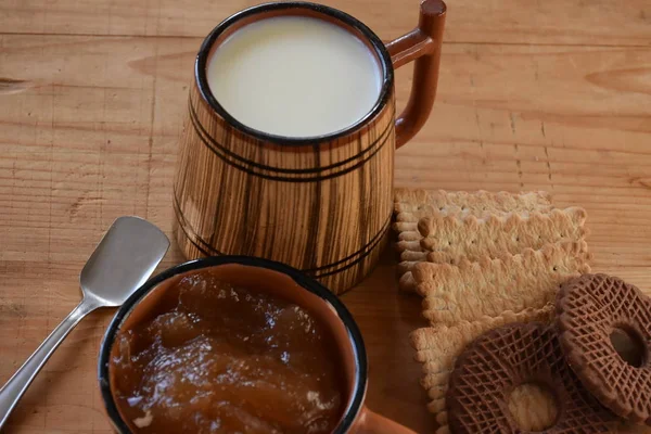 big wooden cup of milk and cookies