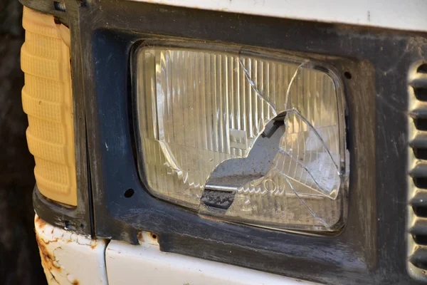 Closeup of old car with broken headlight