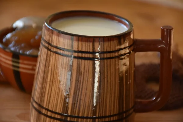 big wooden cup of milk and cookies