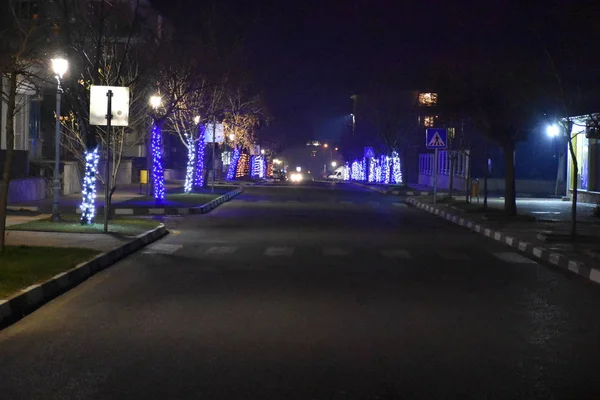 Illuminated empty city road at night