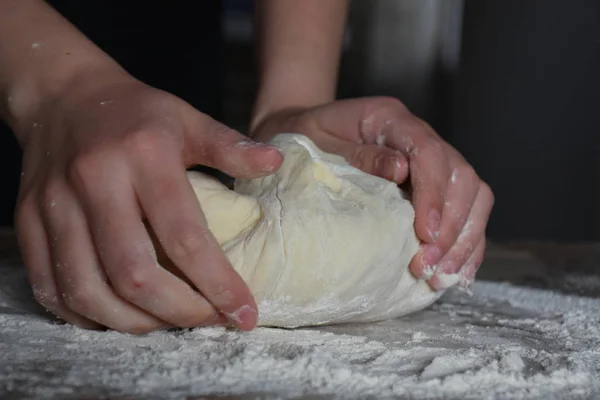 woman knead dough by hands