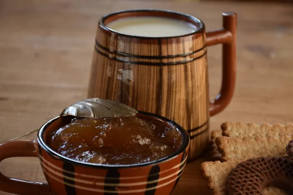 big wooden cup of milk and cookies