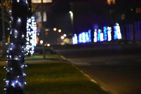 Illuminated empty city road at night