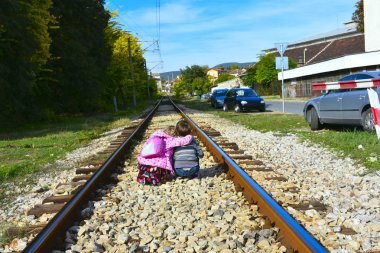Kız ve oğlan demiryolunda.