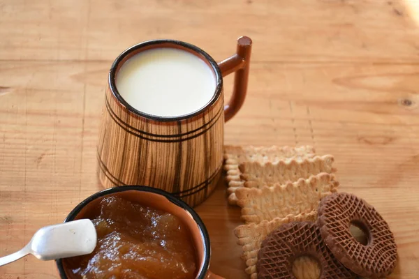 big wooden cup of milk and cookies