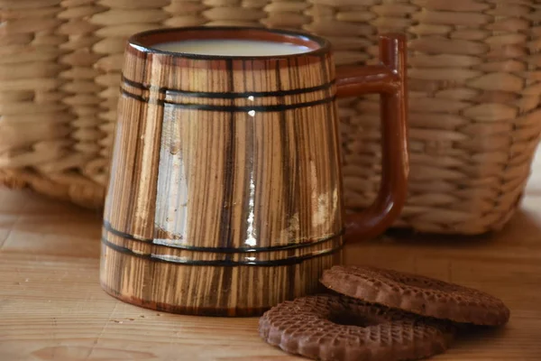 big wooden cup of milk and cookies