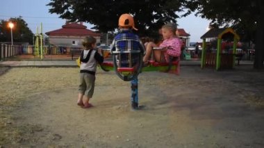 Three happy children are having fun on playground