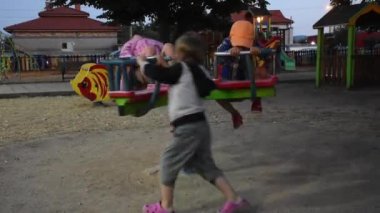 Three happy children are having fun on playground