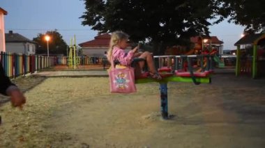 Little boy and girl having fun on playground