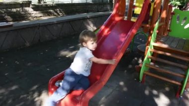 Handsome little boy having fun on playground 