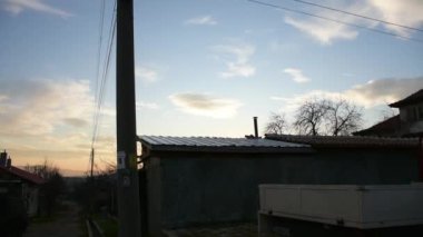 Evening footage of village houses against cloudy sky 