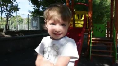 Handsome little boy having fun on playground 