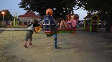 Three happy children are having fun on playground
