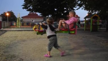 Little boy and girl having fun on playground