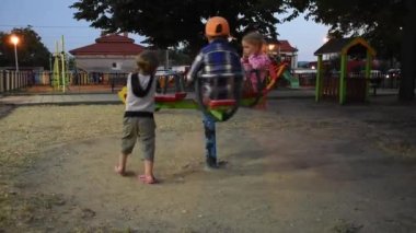 Three happy children are having fun on playground