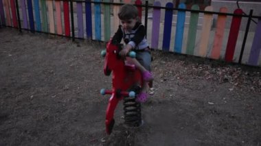 Little happy boy having fun on playground