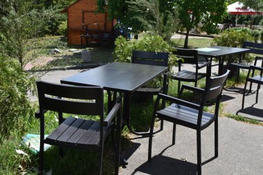 wooden tables and chairs in house yard 