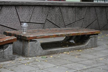 Close up shot of wooden bench at the street.