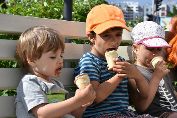 children eat ice cream in summer