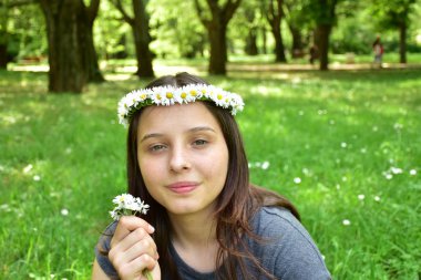  Kafasında papatya çelengi olan bir kızın portresi