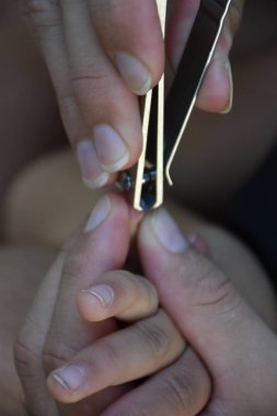 Close up shot of father making manicure to his son