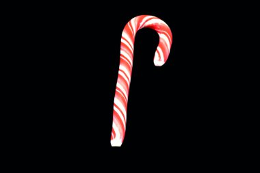 striped red candy on black background.