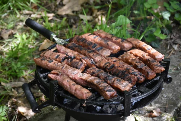 outdoor grilled sausages on a barbecue