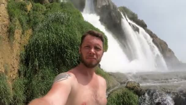 Selfie man. Male taking Self Photo Vlog under Waterfall — Stock Video