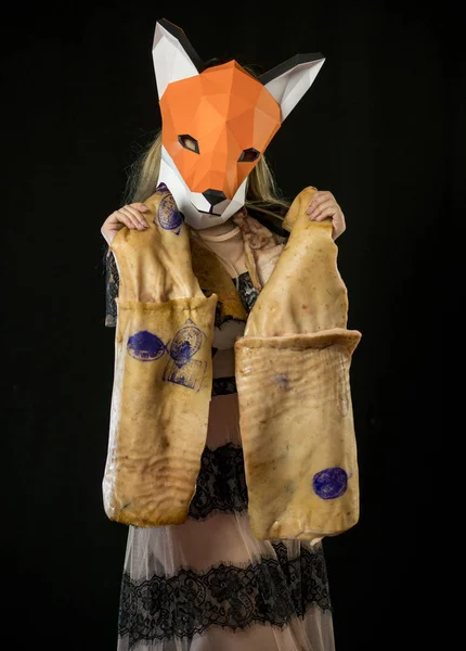 Blonde Girl with Fox Mask paper Using Pig Skin for Covering. Dead Animal Consumer
