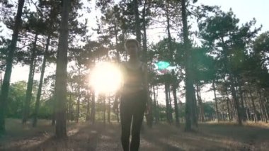 Genç oldukça Punk kız yaka ve siyah kumaş pembe saçlı günbatımı zaman çam ormanda yürüyüş