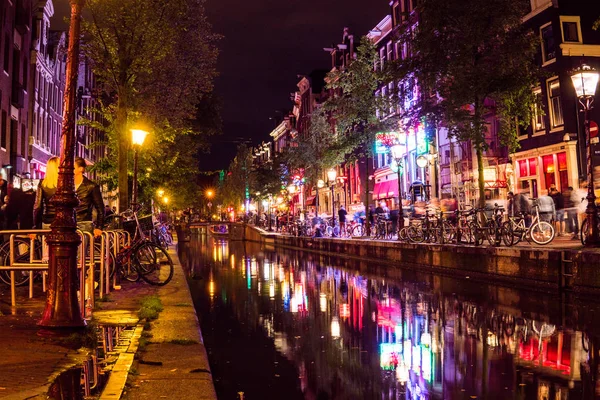 AMSTERDAM - AUG 23: Red Light District on December 3, 2012 in Amsterdam. It is the citys most famous tourist spot. There are over 500 windows in the city and about 1000 working girls. — Stock Photo, Image