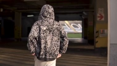 Genç holigan streetstyle adamın sonbahar akşam futbol stadyumu üzerinde çıktığını