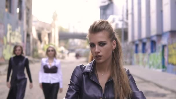 Four freaky fashion leather girls and black motorcycle. Young sexy punk women in urban graffiti scene — Stock Video