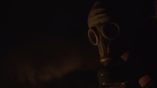 Stalker survivor Soldier Close-up Portrait wearing Gas Mask in an Apocalypse War scenario Sitting with old-style rifle near the fire — Stock Video