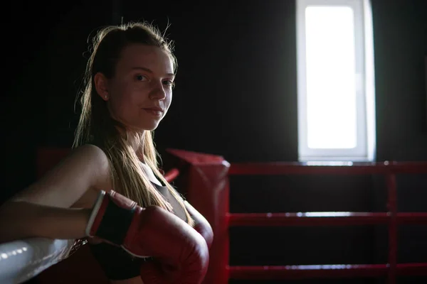 Blonde Caucasian fighter girl in Red Boxing Gloves is posing on Fight club boxing ring — Stock Photo, Image
