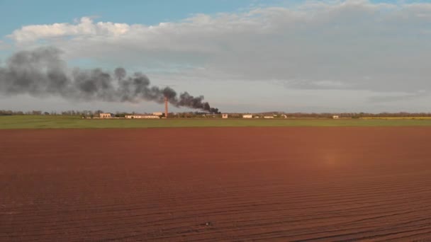 Büyük kırmızı tuğla tüp ile terk edilmiş bir yerde bir yangından büyük siyah duman — Stok video