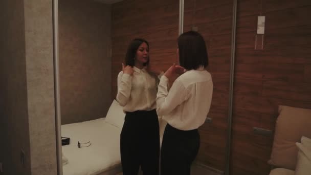 Woman near the big mirror in Cozy Lowlight bedroom — 비디오
