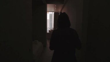 Sevimli şık esmer kız onu yeni daireler geliyor, koridor geçiyor ve güzel bir görünüm ile pencereye geliyor