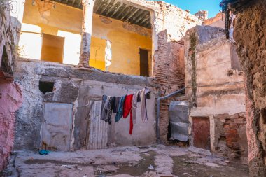 Şehir merkezinde Pembe Fas cephe. Kuruyan asma giydirme ile pencere. Harabeler, fakir bölge. Yıkım. Yaşam tarzı. Marakeş'te evler geleneksel olarak pembedir. Fas